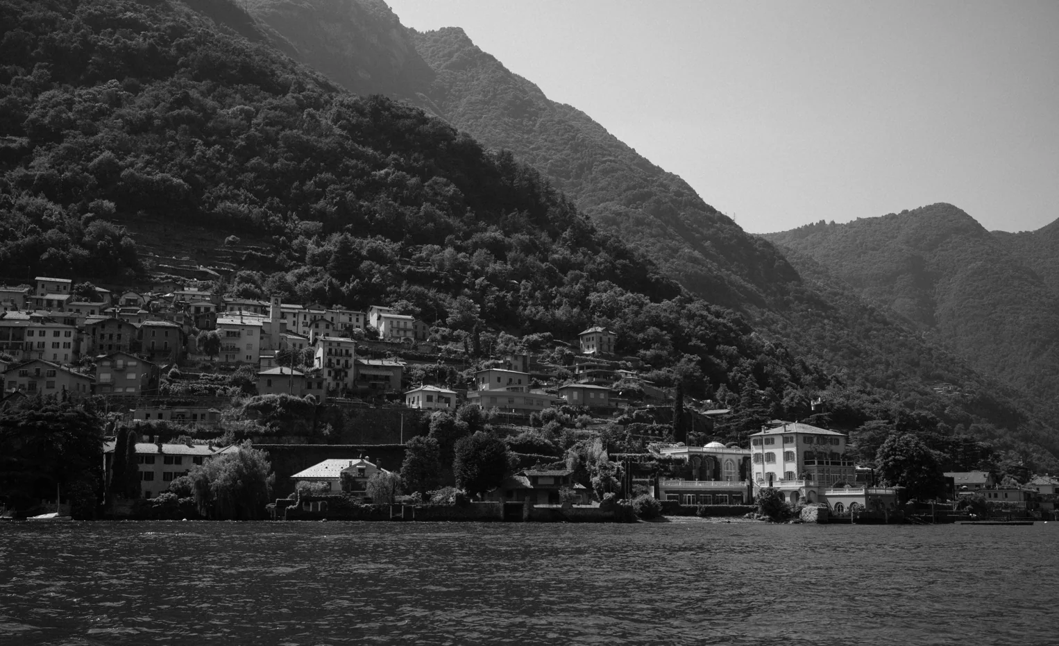 Black and white view across a lake toward the mountains