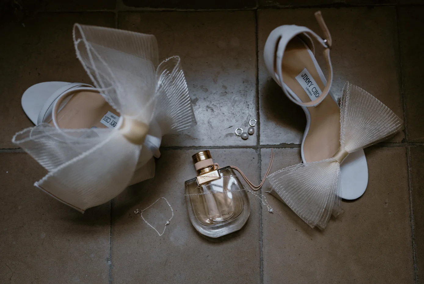 Wedding shoes and fragrance arranged as bridal details
